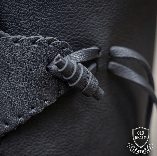 Close-up of laces and toggle on black medieval boots for LARP & Cosplay, handmade full-grain leather craftsmanship.