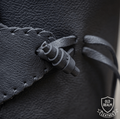 Close-up of laces and toggle on black medieval boots for LARP & Cosplay, handmade full-grain leather craftsmanship.