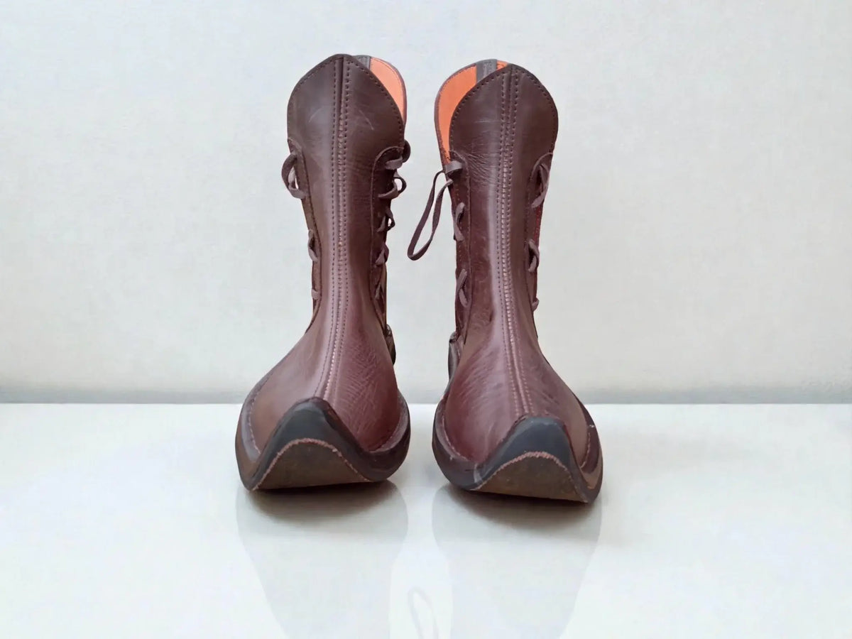 Handmade medieval leather boots with wrap laces and full-grain texture, ideal for LARP or SCA reenactment footwear.